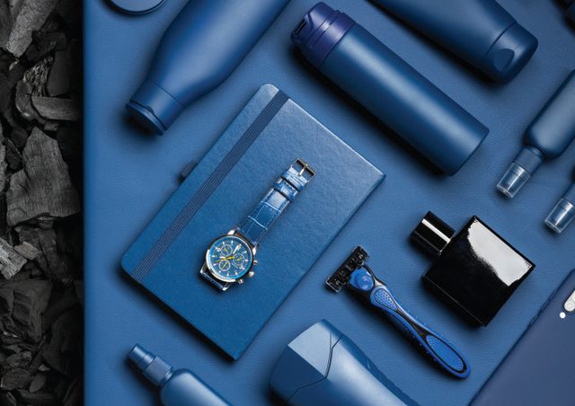 A branded corporate gift set arranged on a dark blue surface.